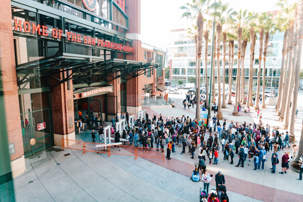 Front entrance view of Oracle Park with people lined up to go inside.