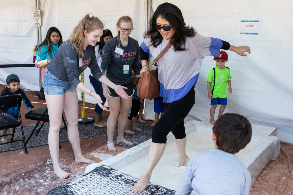 Woman walking through Oobleck activity.